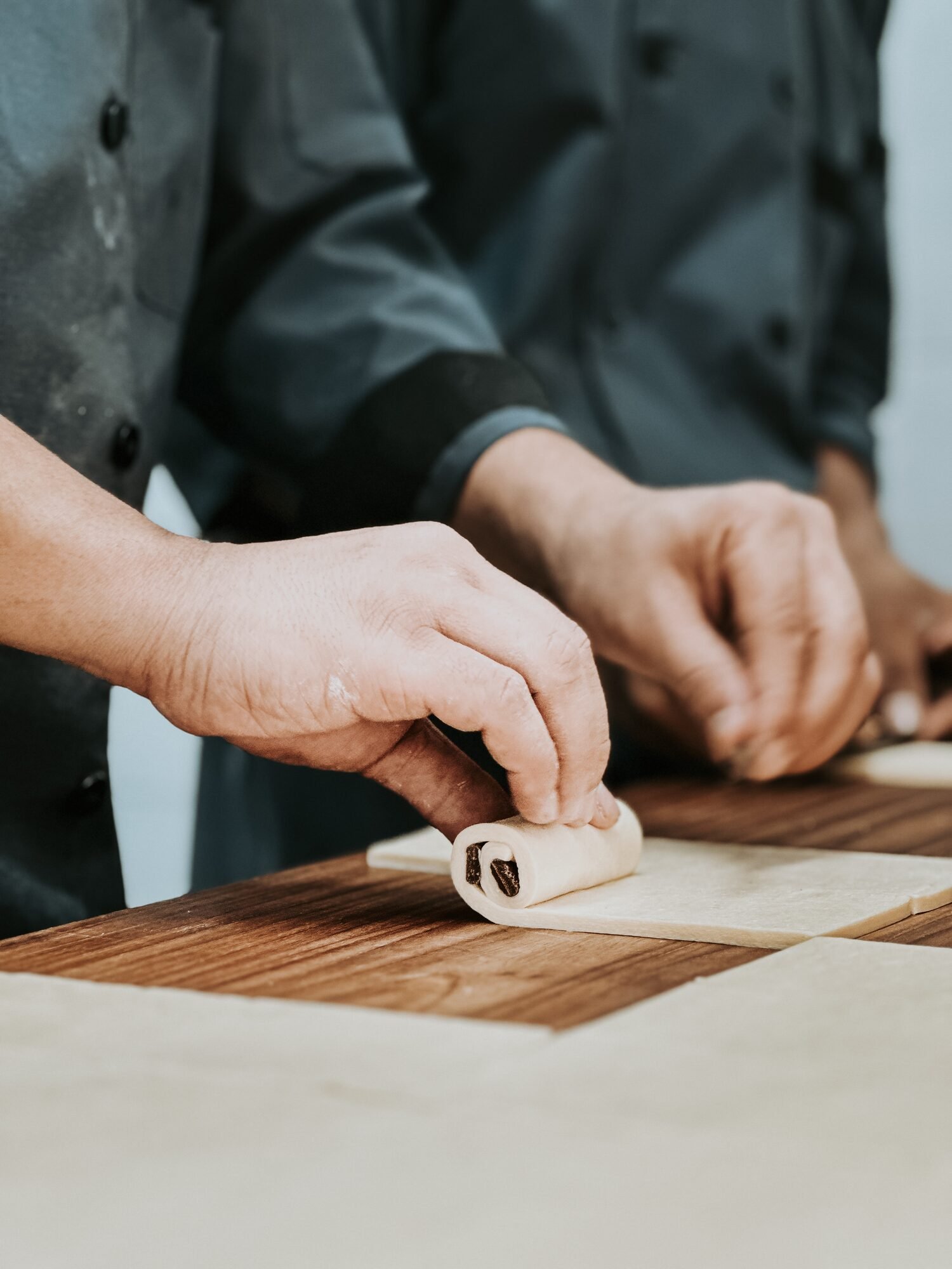 Breadko bakers hand-laminating pastry dough in Ahmedabad kitchen